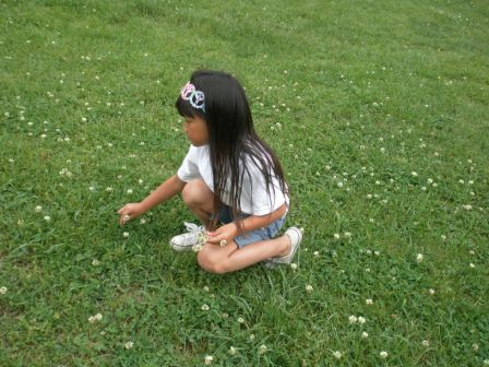 Kasen picking flowers at the park